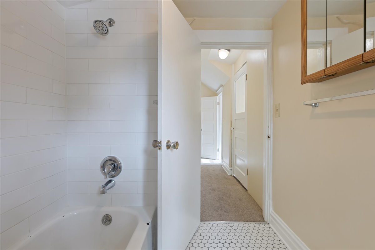 710 South Martin Luther King Junior Avenue Waukegan, IL 60085 - Photo 24 of 35 a bathroom with a bathtub and a shower