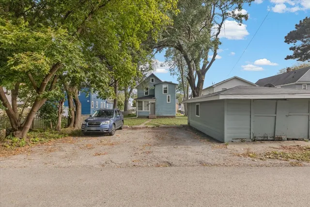 a view of a house with a yard and garage