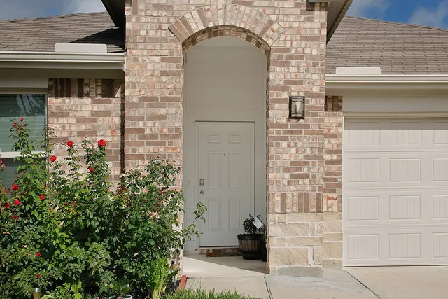 a front view of a house with a potted plant and garage