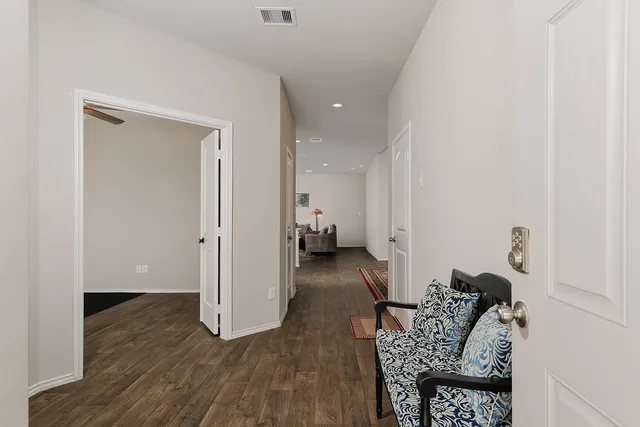 an empty room with a window and a ceiling fan
