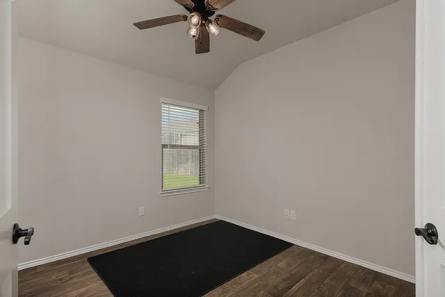 a kitchen with refrigerator a stove a kitchen island and chairs with wooden floor