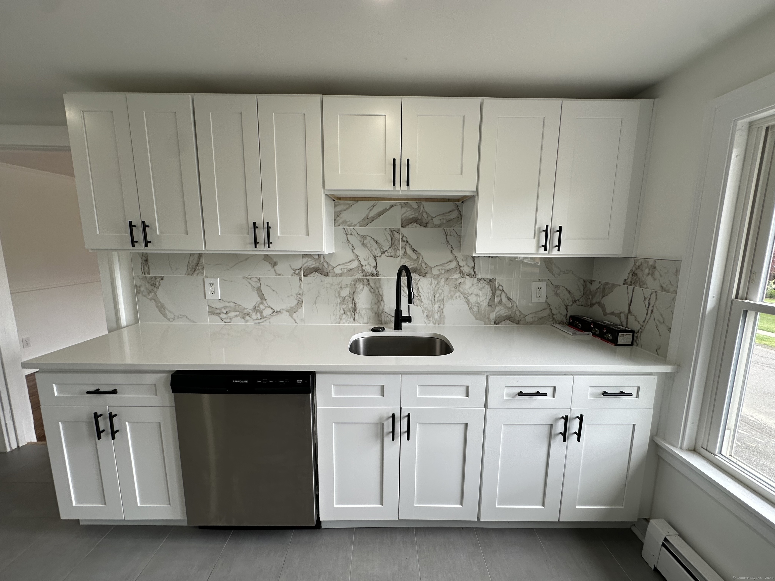 a kitchen with white cabinets and a sink