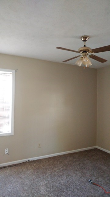5945 Mill Branch Road Columbus, GA 31907 - Photo 3 of 7 an empty room with a window and a ceiling fan