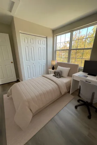 a bedroom with a bed and wooden floor