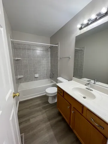 a bathroom with a double vanity sink toilet and shower