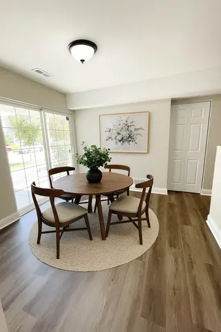 a dining room with furniture and wooden floor
