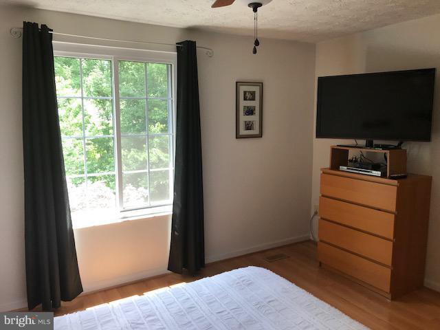 1644 Barnstead Drive Reston, VA 20194 - Photo 11 of 23 a bedroom with a bed and a flat screen tv