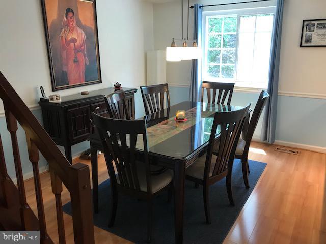 1644 Barnstead Drive Reston, VA 20194 - Photo 4 of 23 a view of a dining room with furniture window and wooden floor
