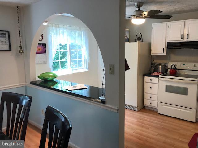 1644 Barnstead Drive Reston, VA 20194 - Photo 5 of 23 a kitchen with stainless steel appliances a white counter top space wooden floor and window