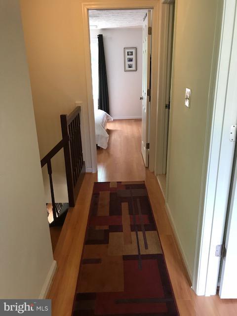 1644 Barnstead Drive Reston, VA 20194 - Photo 9 of 23 a view of a hallway with wooden floor and staircase