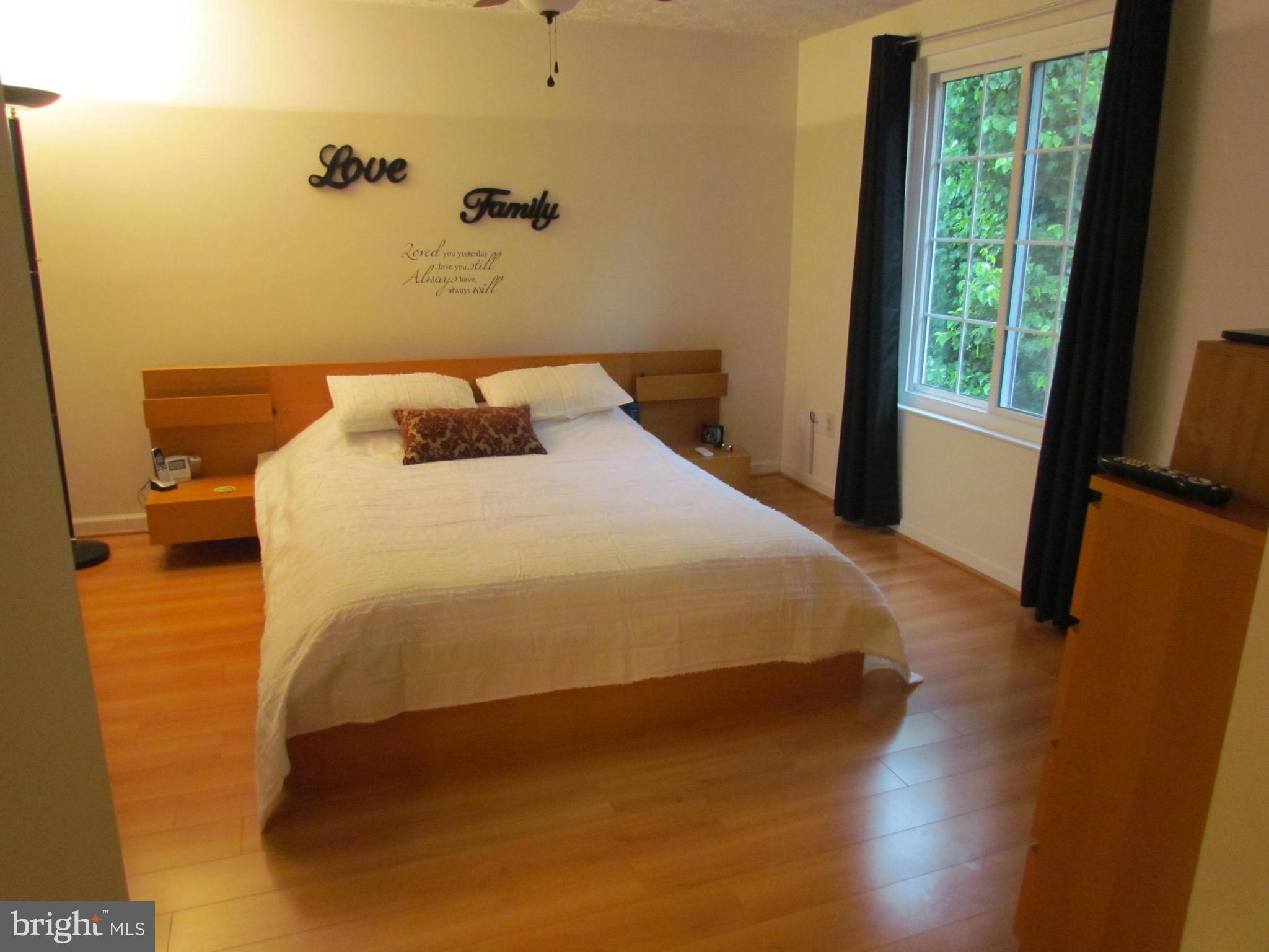 1644 Barnstead Drive Reston, VA 20194 - Photo 10 of 23 a large bed sitting in a bedroom next to a window