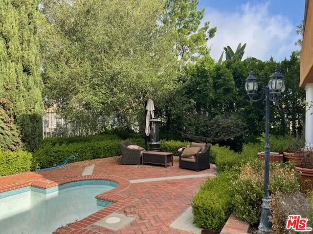 a backyard of a house with a yard and outdoor seating