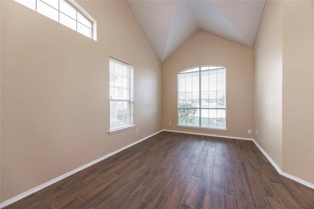 9201 Hunter Chase Drive McKinney, TX 75072 - Photo 12 of 35 an empty room with wooden floor and windows