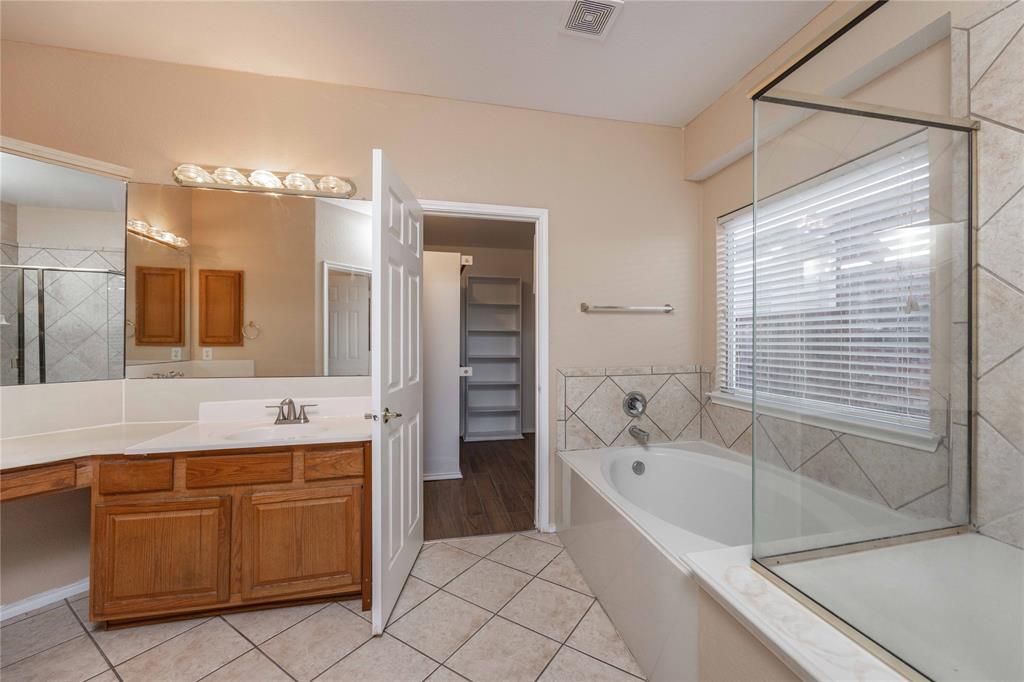 9201 Hunter Chase Drive McKinney, TX 75072 - Photo 14 of 35 a spacious bathroom with a tub sink and mirror