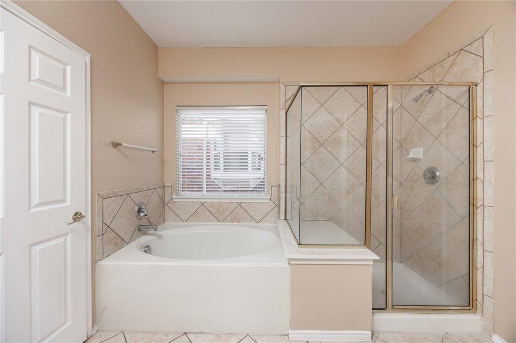 9201 Hunter Chase Drive McKinney, TX 75072 - Photo 16 of 35 a white bath tub sitting next to a shower