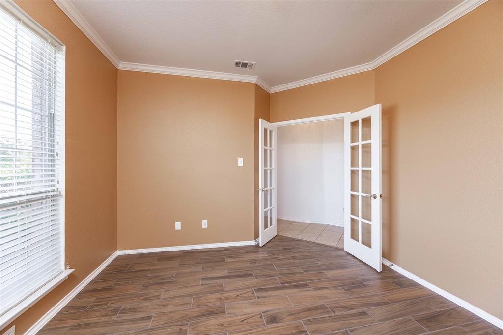 9201 Hunter Chase Drive McKinney, TX 75072 - Photo 19 of 35 a view of an empty room with wooden floor and a window