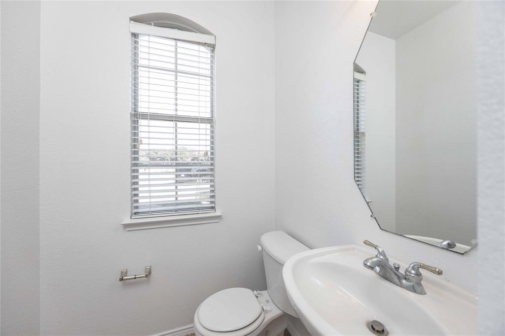 9201 Hunter Chase Drive McKinney, TX 75072 - Photo 20 of 35 a bathroom with a sink mirror and toilet