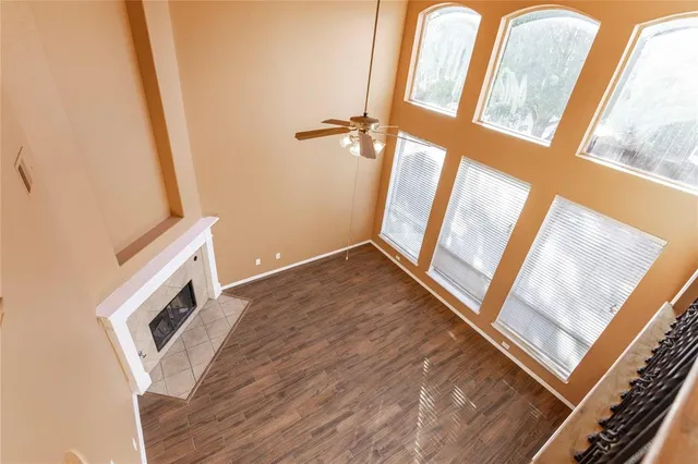 a view of an empty room and wooden floor