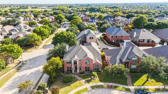 an aerial view of multiple houses with yard