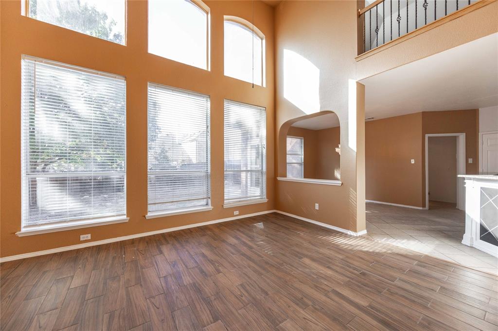 9201 Hunter Chase Drive McKinney, TX 75072 - Photo 4 of 35 a view of an empty room with wooden floor and a window