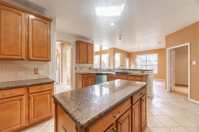 a kitchen with stainless steel appliances granite countertop a sink and a counter space