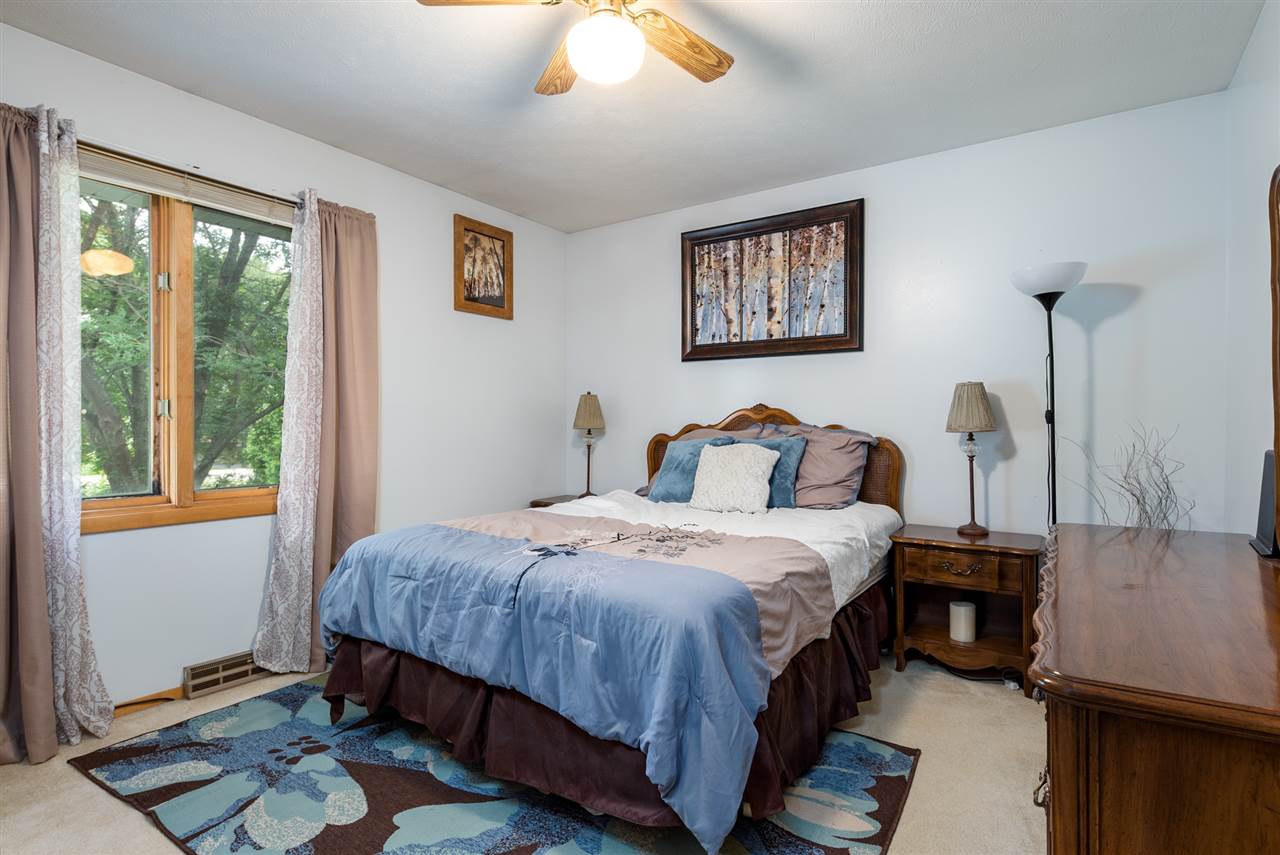 10111 Beaver Valley Road Belvidere, IL 61008 - Photo 15 of 25 a bedroom with a bed and wooden floor