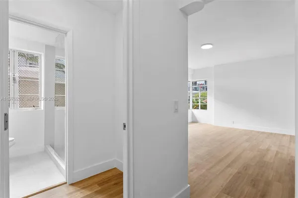 a view of hallway with wooden floor
