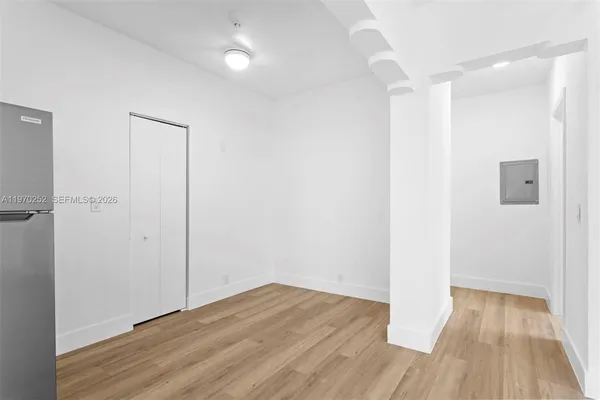 a view of a room with wooden floor