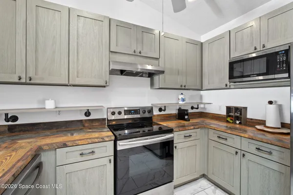 a kitchen with cabinets stainless steel appliances a sink and a counter space