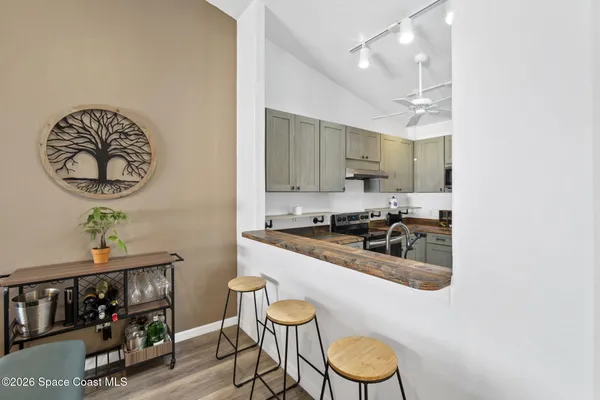 a kitchen with stainless steel appliances granite countertop a sink cabinets and wooden floor