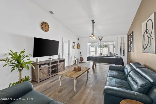 a living room with furniture and a flat screen tv