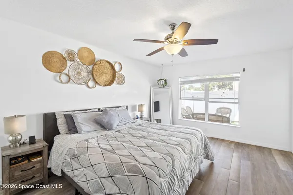 a bedroom with a bed and wooden floor