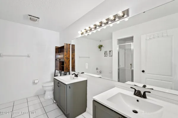 a bathroom with a sink double vanity and a mirror