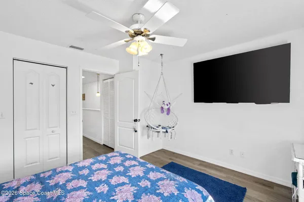 a bedroom with a bed and a flat screen tv