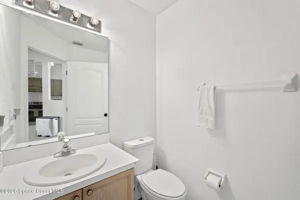 a bathroom with a sink toilet and mirror