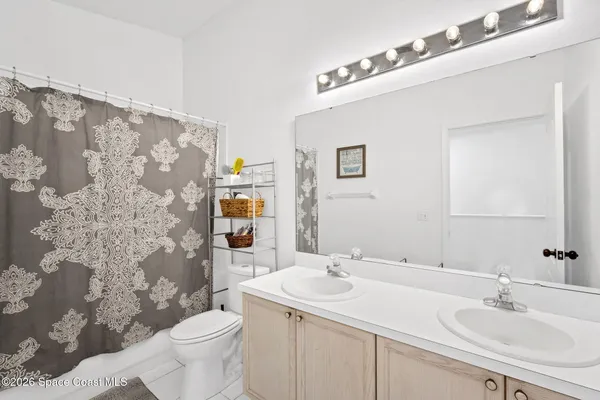 a bathroom with a sink and mirror with toilet