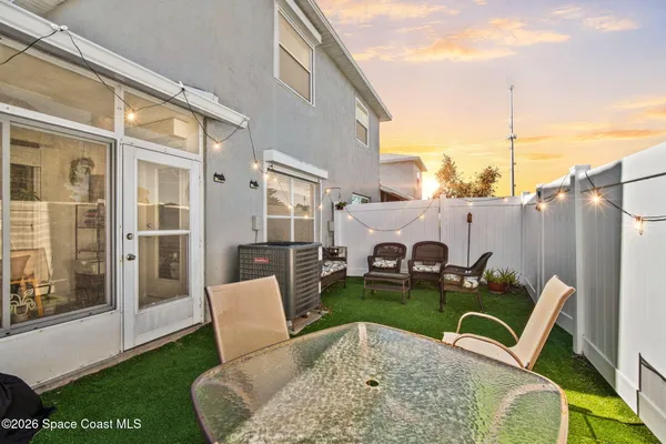 a view of a patio with couches chairs and potted plants