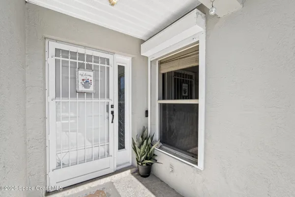 a view of an entryway door front of a house