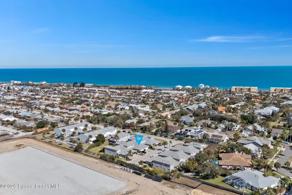 an aerial view of residential houses with outdoor space