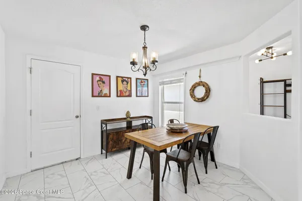 a view of a dining room with a table and chairs