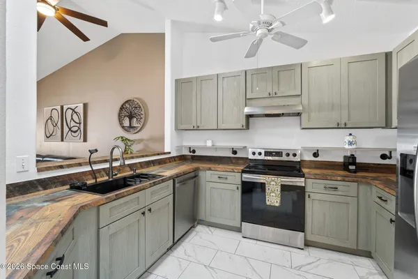 a kitchen with a sink cabinets and window