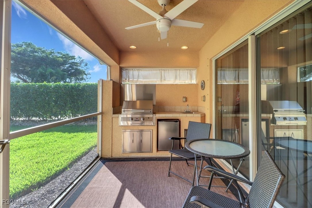 19674 Villa Rosa Loop Estero, FL 33967 - Photo 15 of 33 a kitchen view with table chairs refrigerator and stove