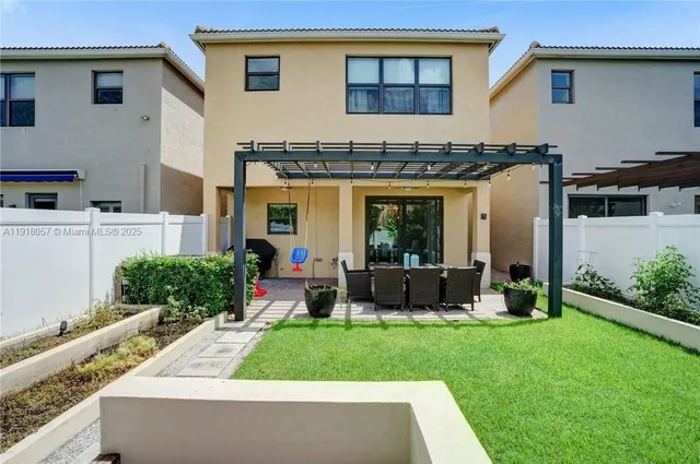 a front view of house with yard and outdoor seating