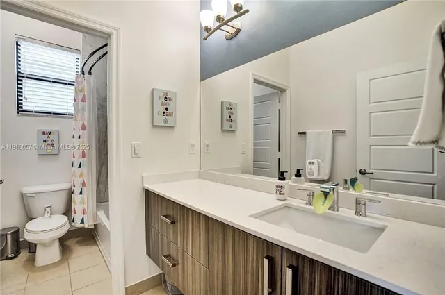 a bathroom with a sink double vanity and a toilet
