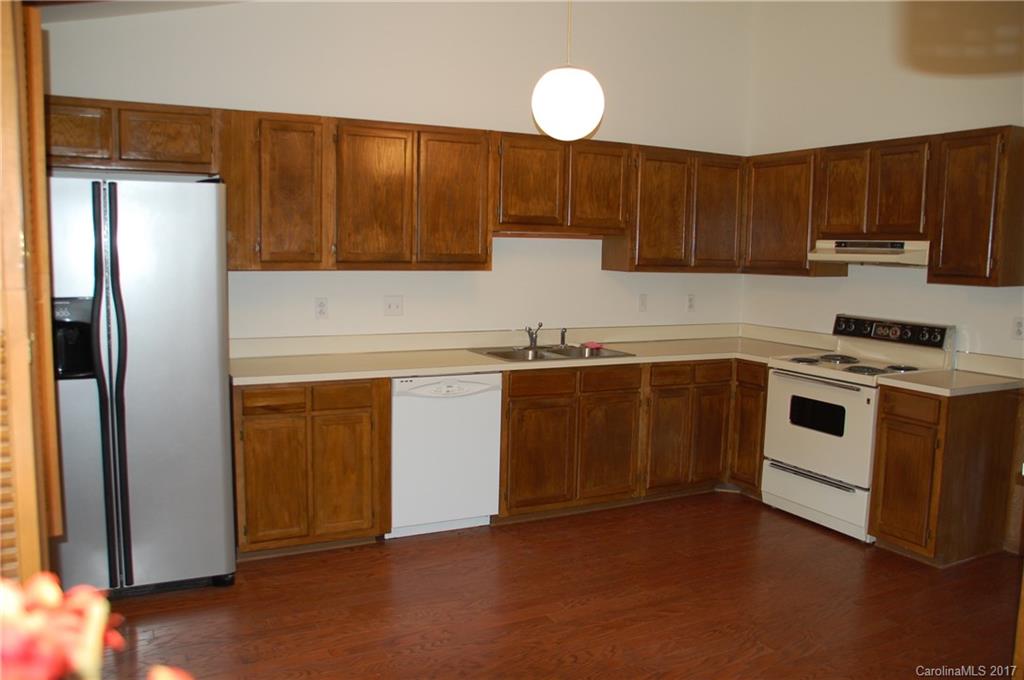 715 Trail Ridge Road Matthews, NC 28105 - Photo 9 of 13 a kitchen with a sink a stove and refrigerator