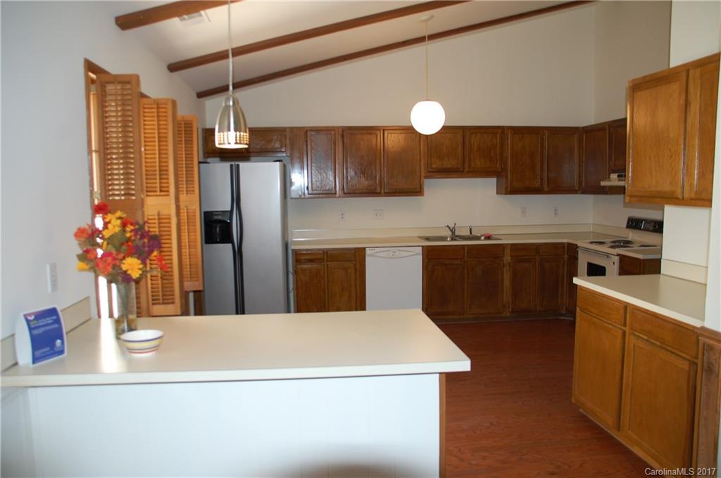 715 Trail Ridge Road Matthews, NC 28105 - Photo 10 of 13 a kitchen with stainless steel appliances a sink a refrigerator a center island a stove and cabinets