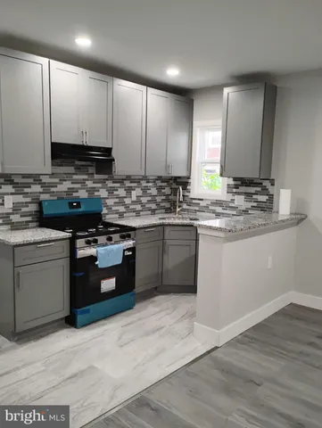 a kitchen with stainless steel appliances granite countertop a stove a sink dishwasher and a refrigerator