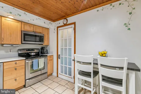 a kitchen with wooden cabinets and stainless steel appliances