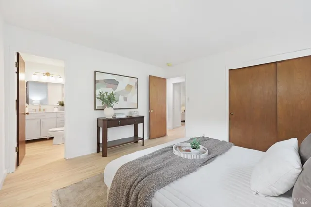 a bathroom with a toilet a sink a mirror a vanity and shower