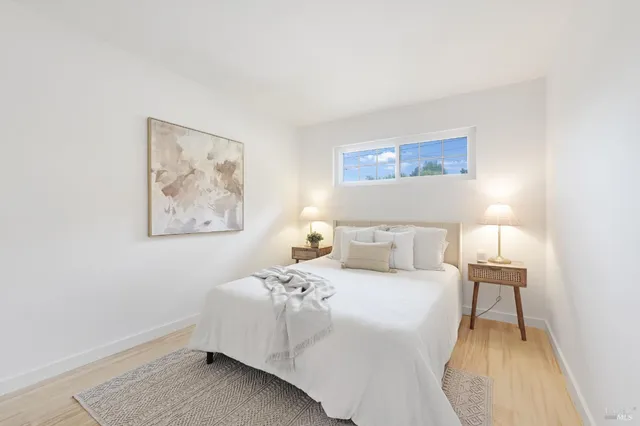 a bedroom with a bed and wooden floor